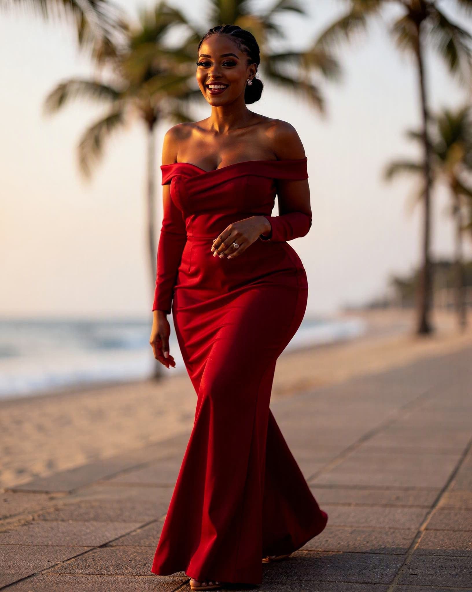 Lindiwe in a red gown on the Durban beachfront — a No Safe Word character