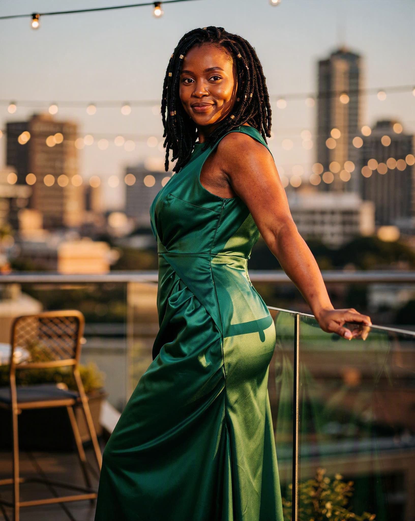 Palesa in an emerald evening gown on a Sandton rooftop — a No Safe Word character